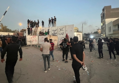 Protesters scale a wall at the Swedish Embassy in Baghdad