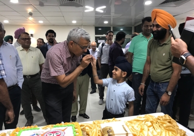 Ravjot Offering a piece of cake to Dr. Ashish 